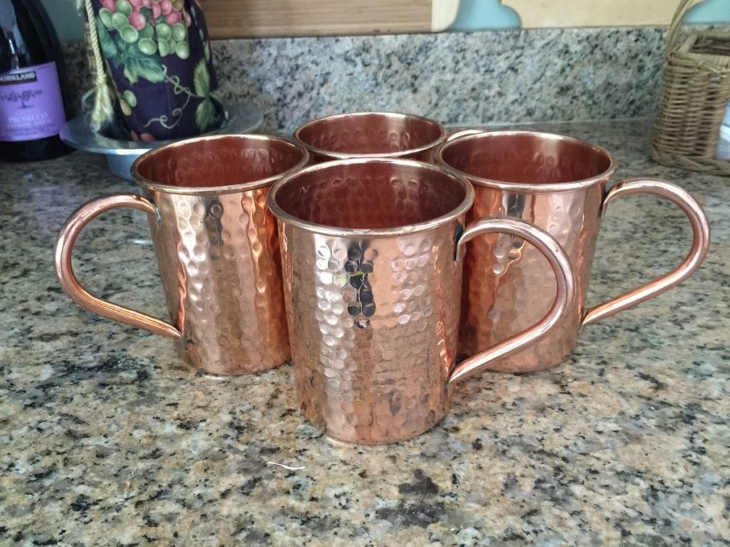Moscow Mule Cooper Mug Set • A set of 4 mugs that not only look wonderful on display, but also keep your favorite beverage cold. These dimpled mugs with their bright copper color will delight your guests.