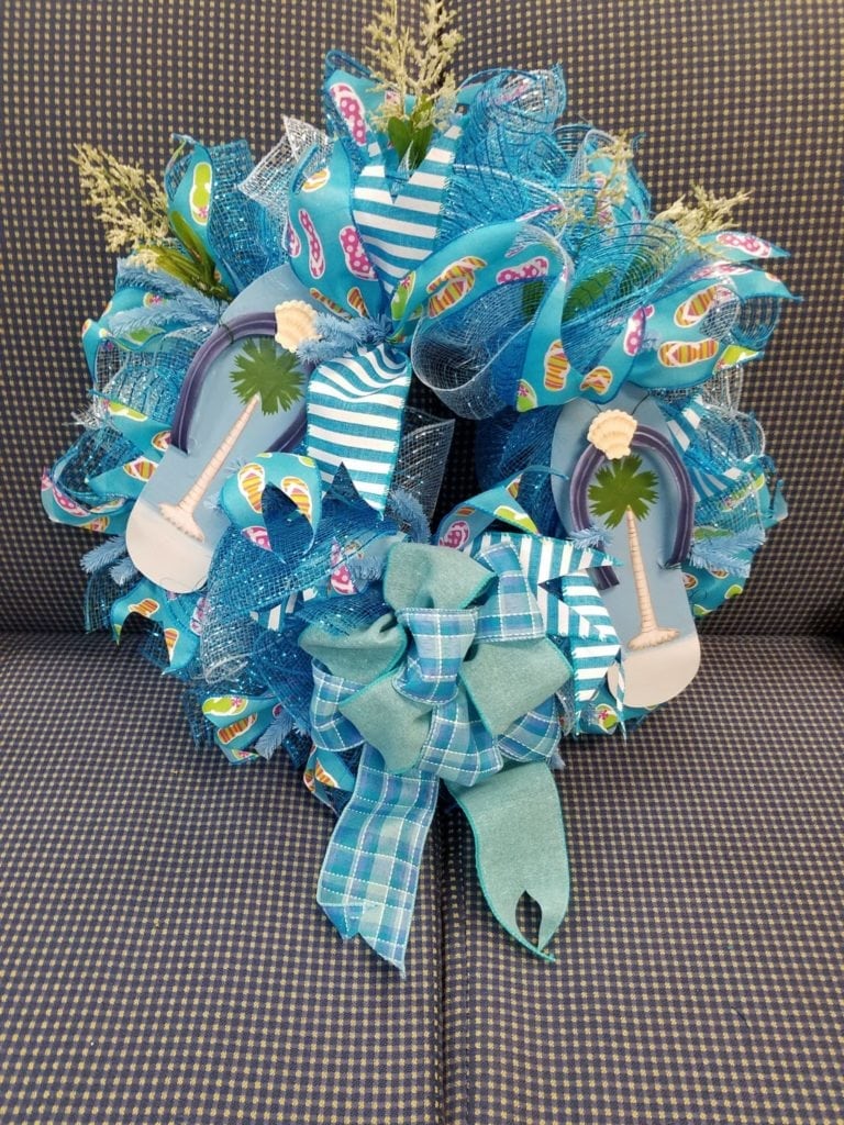 Flip flop wreath • Locally made wreaths, this one highlighting flip flops with beautiful beachy colors.