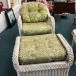 White Wicker Chair w/Ottoman • White wicker chair and white wicker ottoman. Lovely green and white flowered fabric. This piece would be a great addition to a sunroom.