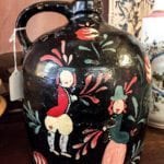 Folk Art Jug - Vintage • Vintage hand painted black folk art jug with characters. This black jug with accents of red will liven up any buffet in a dining room or give your bookshelf some pizazz. A unique item that is not found in mass market stores.