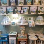 Hand painted home decor • This local artist paints beautiful beach scenes. You can choose from furniture, lampshades, lamps, landscapes on windows and a large assortment of switchplate covers. If you need a custom piece done, no problem.