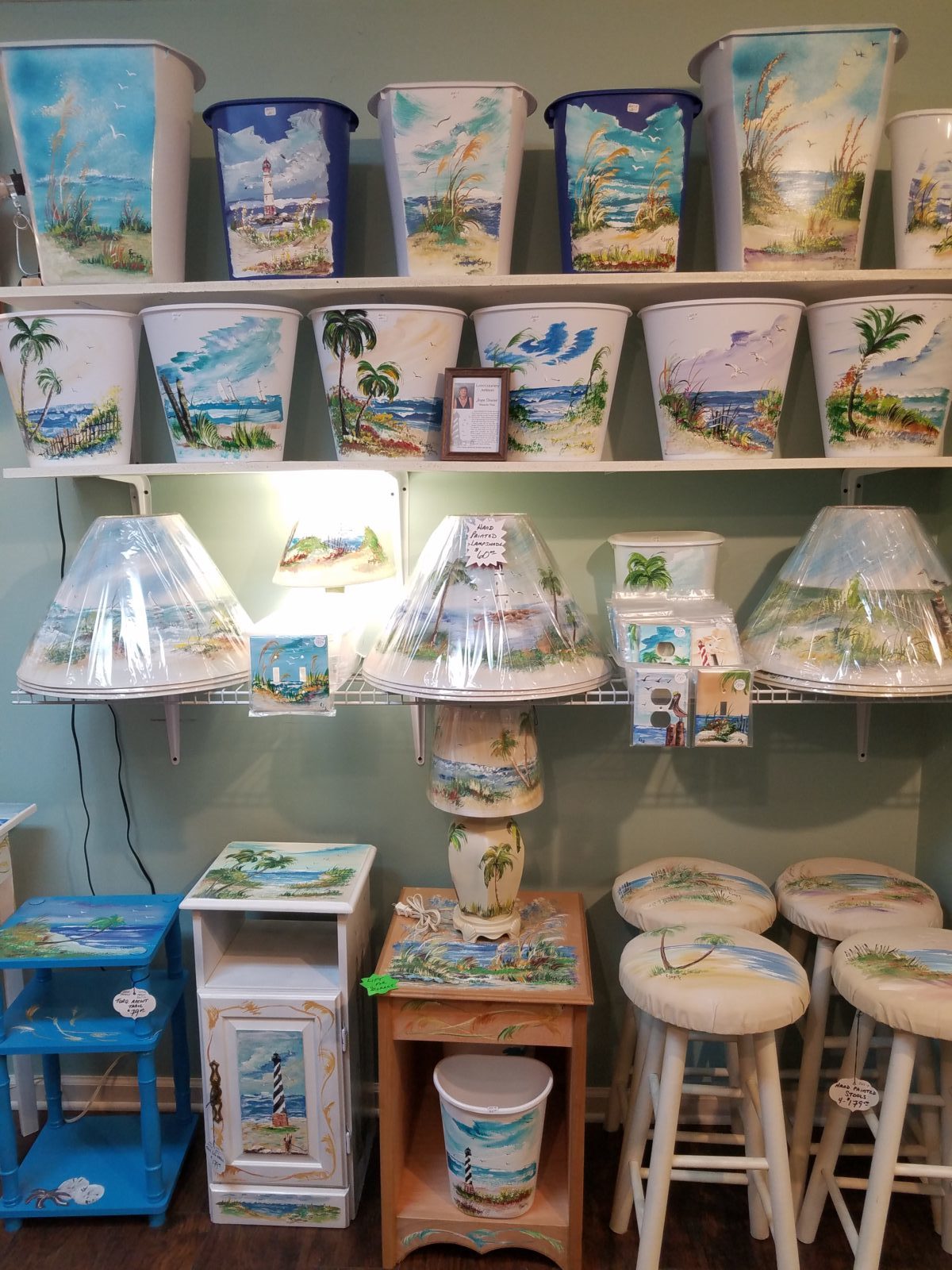 Hand painted home decor • This local artist paints beautiful beach scenes. You can choose from furniture, lampshades, lamps, landscapes on windows and a large assortment of switchplate covers. If you need a custom piece done, no problem.