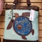 Chala crossbody bag • This whimsical turtle crossbody is the perfect size! Stop by and see our total collection. We can also special order for you if you don't see what you want.