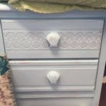 Shell Nightstands • Bring the beach home with one or both of these two drawer Nightstands featuring a shell design and decorative shell knobs. Pair with one of our chalk painted beds to create the perfect, inviting bedroom for home or your place at the beach