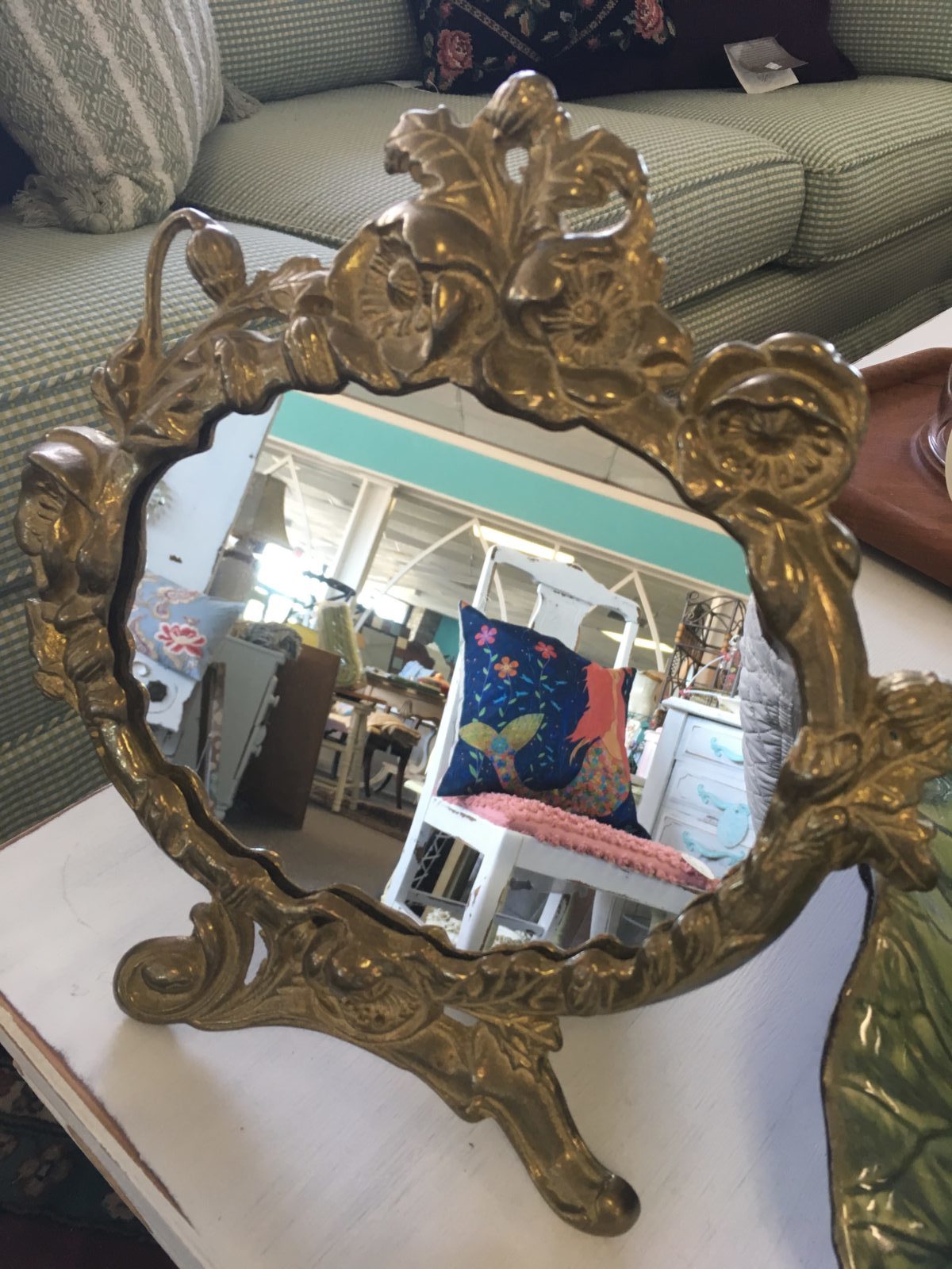 Vintage Brass Vanity Mirror • Vintage brass standing vanity mirror on easel is made of heavy brass with an attractive floral design surrounding the oval shaped mirror. Wonderful, thoughtful gift sure to add a touch of elegance to any table, vanity or bathroom.