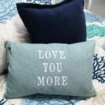 Love You More Pillow • This 12" x 18" Pillow says it all..."Love You More" ...what a wonderful Valentine's Day Gify for that special someone! Light blue/green chambray fabric cover that zips off for easy cleaning and a goose down feather insert for a squishy, cozy feel.