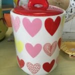 Heart Doggy Treat Jar • Charming ceramic doggy treat jar with a bone as the handle on the lid and an assortment of hearts on the actual jar. Keep doggy treats or be creative and store cotton balls, candies or anything else your "Heart" desires.