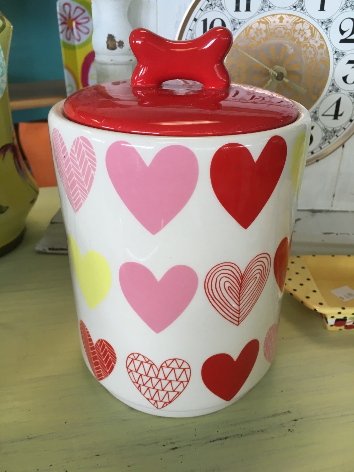 Heart Doggy Treat Jar • Charming ceramic doggy treat jar with a bone as the handle on the lid and an assortment of hearts on the actual jar. Keep doggy treats or be creative and store cotton balls, candies or anything else your "Heart" desires.