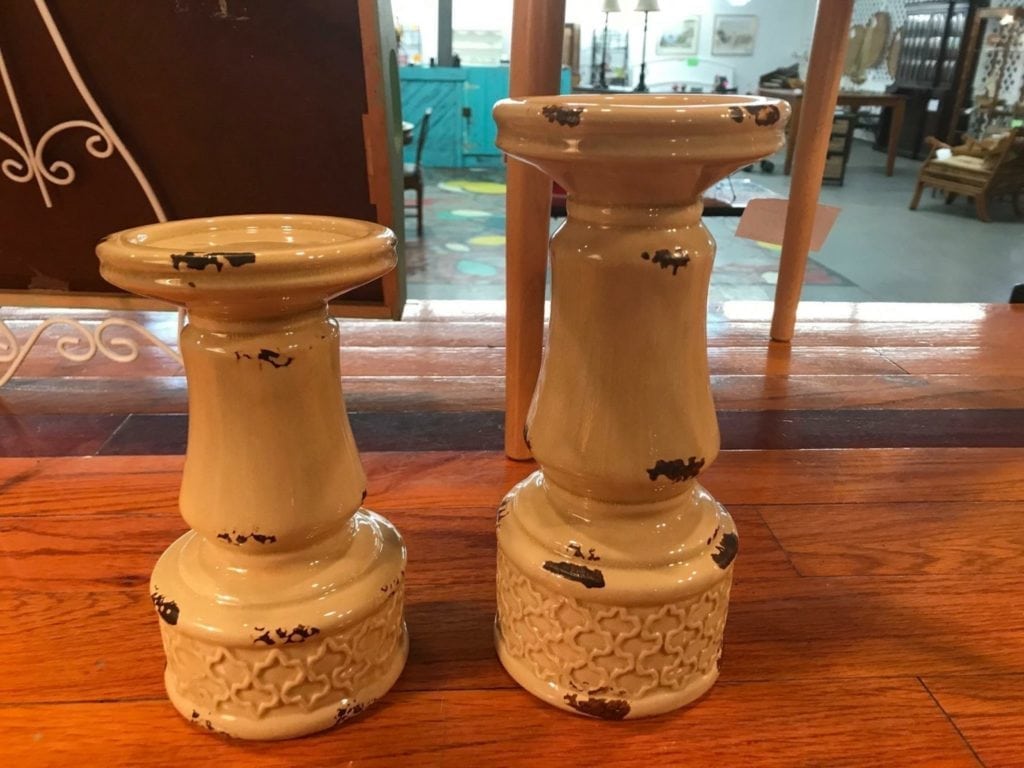 Ceramic pillar candleholders • This pair of ceramic pillar candleholders are a lovely creamy yellow with a rusty distressed look. Candles add lovely ambiance in any room, and this pair is a great neutral color that will compliment any decor.