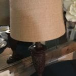Carved Wood Lamp • Neutral brown with burlap shade makes this single lamp a nice addition to your decor! Any place you need additional task or ambient lighting.