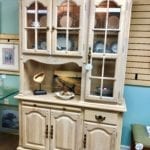 2 Piece China Cabinet • Wonderful off white 2 piece China cabinet. 1 large glass door and 2 small ones. Along with cabinets, a drawer and a slide out board. Lights at top of cabinet.