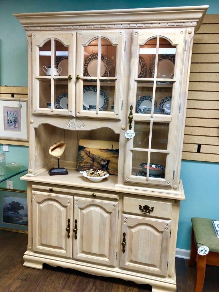 2 Piece China Cabinet • Wonderful off white 2 piece China cabinet. 1 large glass door and 2 small ones. Along with cabinets, a drawer and a slide out board. Lights at top of cabinet.