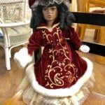 Porcelain Doll w/Burgandy Dress • This beautiful porcelain doll is all dressed up for winter with this burgundy with white fur coat.