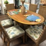 Oval Dining Set w/ 6 chairs • Beautiful oval dining table with 6 chairs. Chairs have a pineapple pattern fabric with a white background. Chairs are a woven rattan and very comfy.