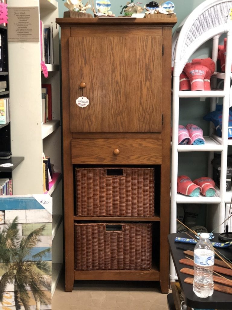 Oak Armoire • Beautiful oak armoire with a cabinet door, one drawer and two baskets below. Great for any entrance to stow shoes, compact umbrellas and more. A pretty piece for any home. On sale for $199