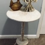 Side or Accent Table • This ReDesin has truly been given a new life with an antique white finish and a raised fleur de lis design. Neutral enough to work in any room.