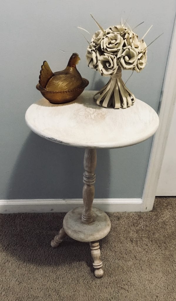 Side or Accent Table • This ReDesin has truly been given a new life with an antique white finish and a raised fleur de lis design. Neutral enough to work in any room.