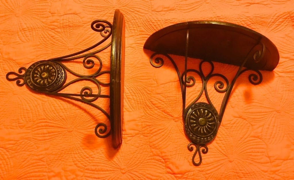 Pair of Wood and Metal Wall Sconces • This pair of wall sconces are a great display item in their own, but picture them as brackets for a custom wall shelf. Display your favorite collection and draw attention to your unique treasures.
Price is for the pair. Delivery options available.